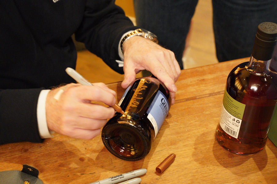 Billy Walker signing bottles